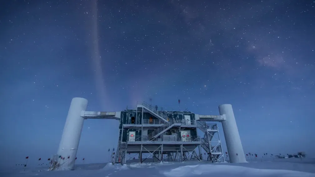 A scientific facility on an ice sheet with a starry night sky. 