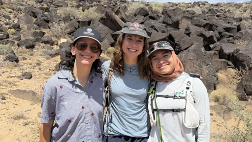 Photo of the science communication interns smiling on a sunny desert hiking trail.