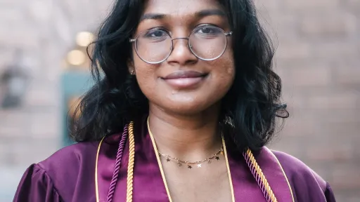Shrada smiling in her down at graduation.