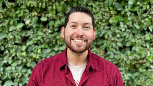 Geo-Launchpad intern Sebastian Griego headshot in front of green foliage. 
