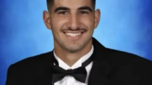 RESESS intern Hassan Saleh in a suit with a blue background.