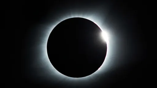 photo of near total solar eclipse, just a small bright spot peeking out on one edge