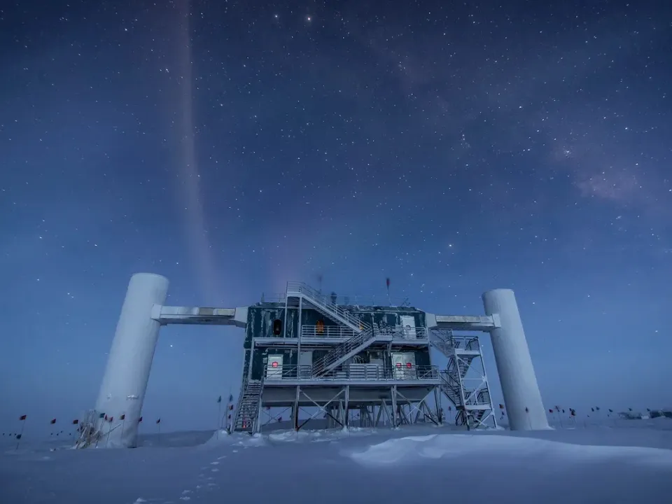 A scientific facility on an ice sheet with a starry night sky. 