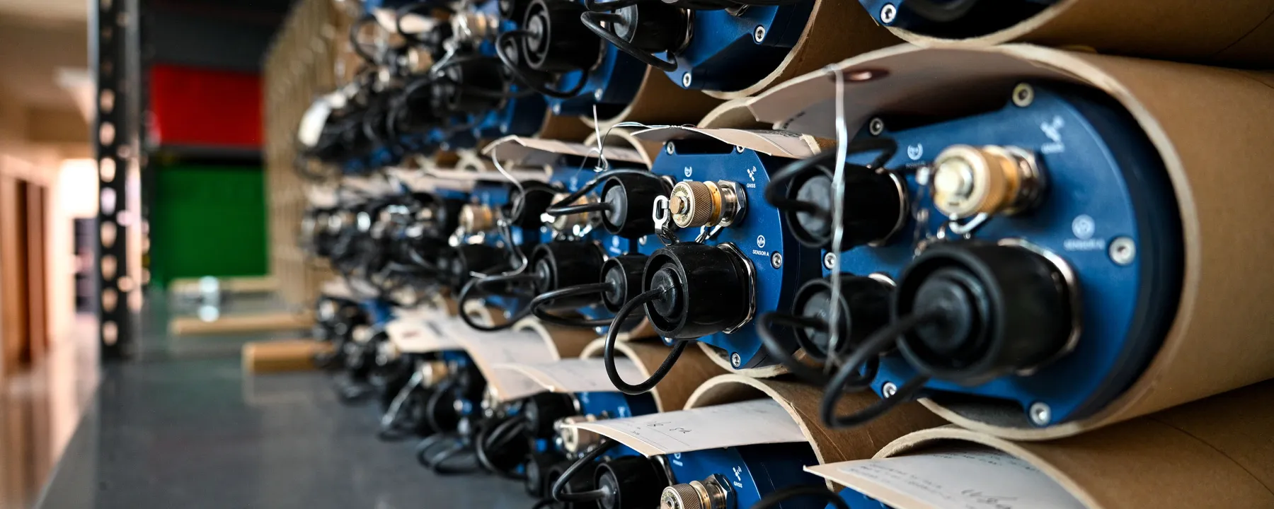 Rows of seismic dataloggers stacked on a shelf.