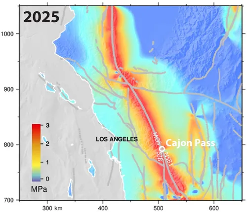 A planar map view of the southern sections of the San Andreas and associated faults. California is oriented so northwest is at the top and southeast is at the bottom. Topography is overlain in gray shades. Simulated stress is shown as an overlay across the map. Red colors appear at the major fault zones, showing high stress up to 3 MPa, while low stress is light blue to dark blue, corresponding to 0 MPa. The gradient trends away from the fault lines. 