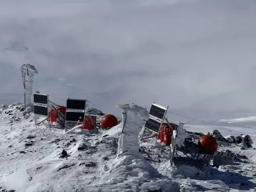 An image of geophysical equipment on an icy, windswept ridge.