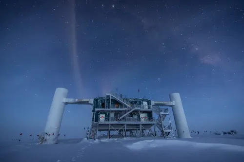 A scientific facility on an ice sheet with a starry night sky. 