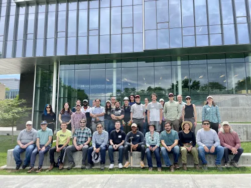 group photo in front of glass building