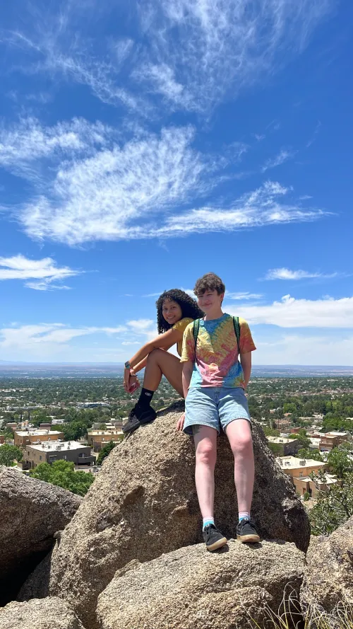 Natalie and another RESESS intern sitting on a rock in the field.