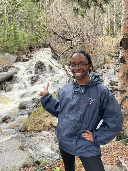 Rori smiling by a waterfall.