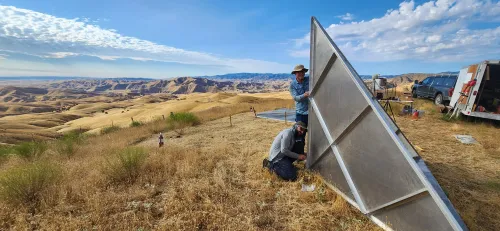 two people assembling metal corner reflector