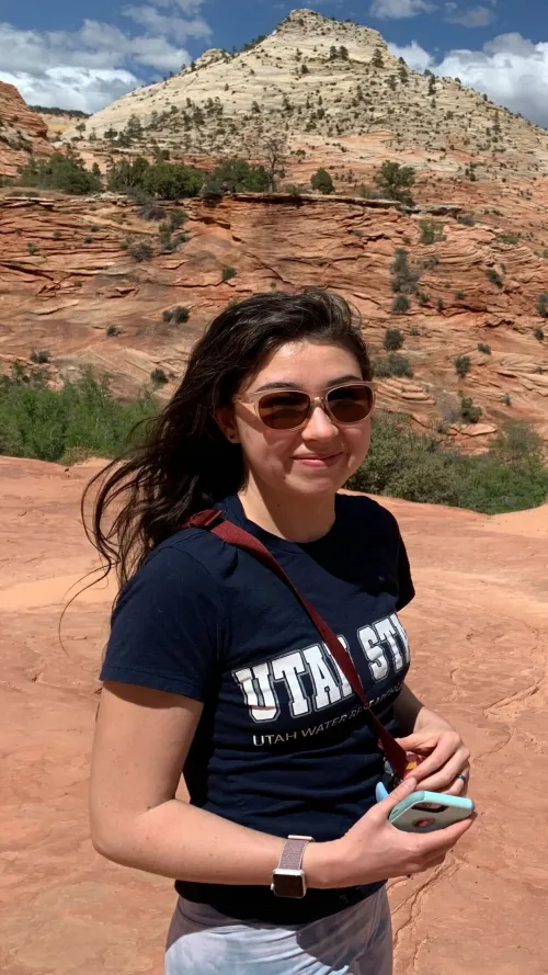 Kitri Spencer outside with sedimentary rocks in the background.