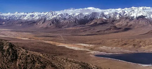 photo looking over brown valley towards snow-capped mountain range