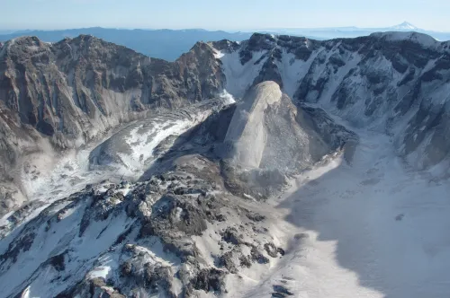 photo looking down into crater of Mount St. Helens with a lava dome protruding up from the crater floor, sloped gently on one side