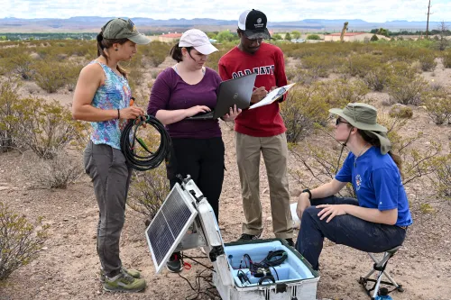 EarthScope engineer Kirsten Arnell and Interns working to deploy a seismometer.