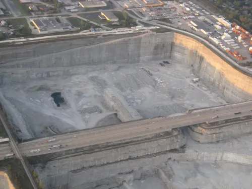Overhead photo of an urban quarry with an interstate highway running across the middle.